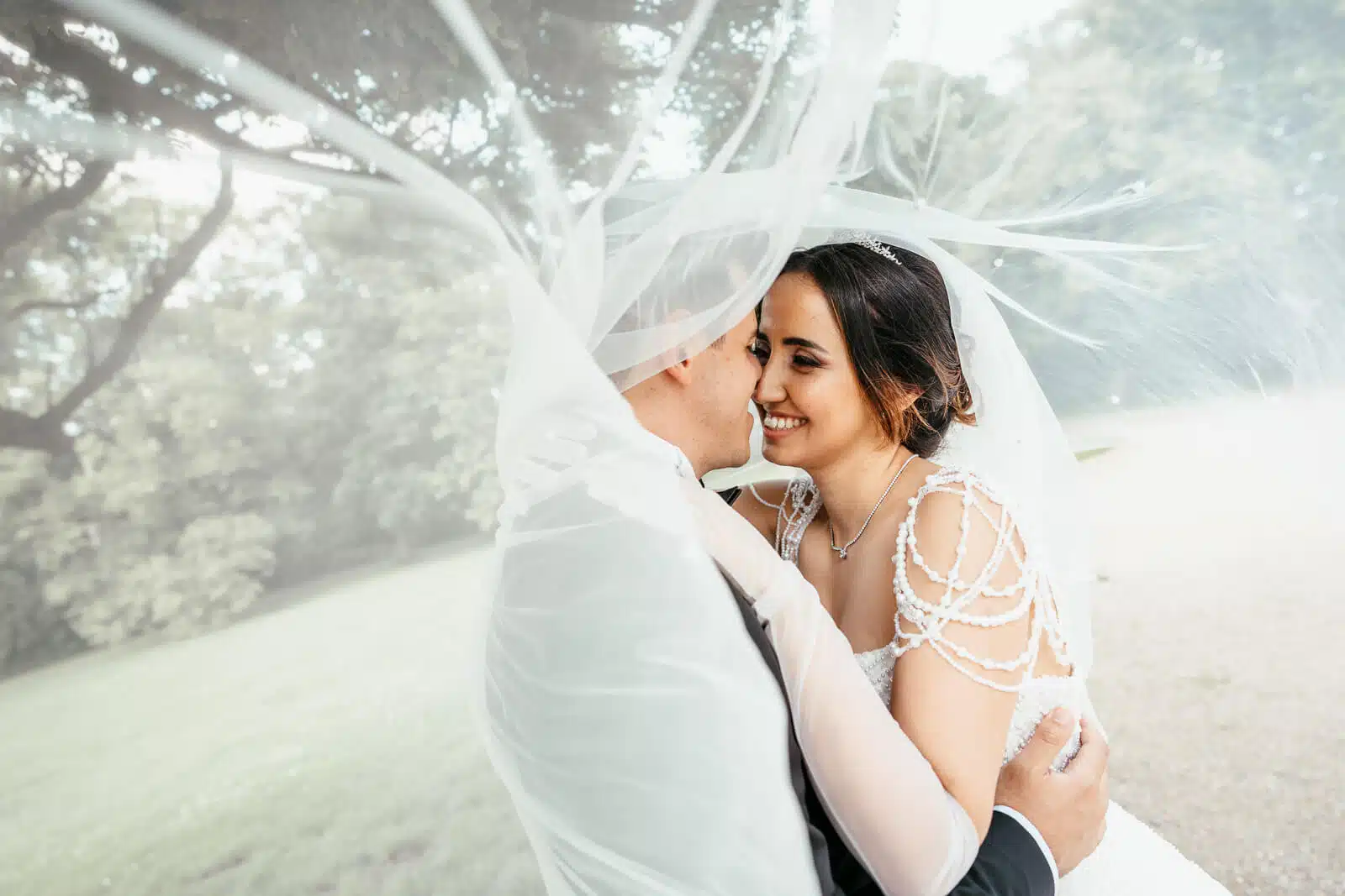 Braut und Bräutigam unter dem Schleier vor Schloss Richmond, emotionaler Moment Hannover Region